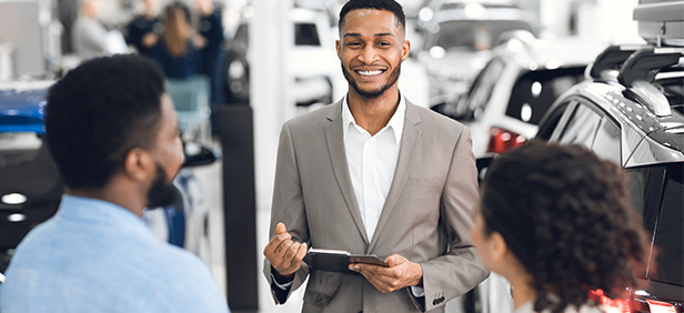 Car dealer smiles a potential buyers.